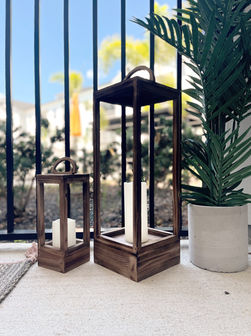Two wooden lanterns with candles to set the mood at night