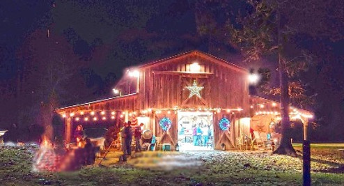 The barn venue lit up in the fall fire in the fire pit holiday party