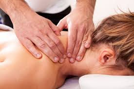 Therapist applying therapeutic bodywork to a woman's neck.