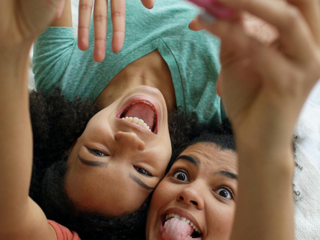 two young teens taking a selfie