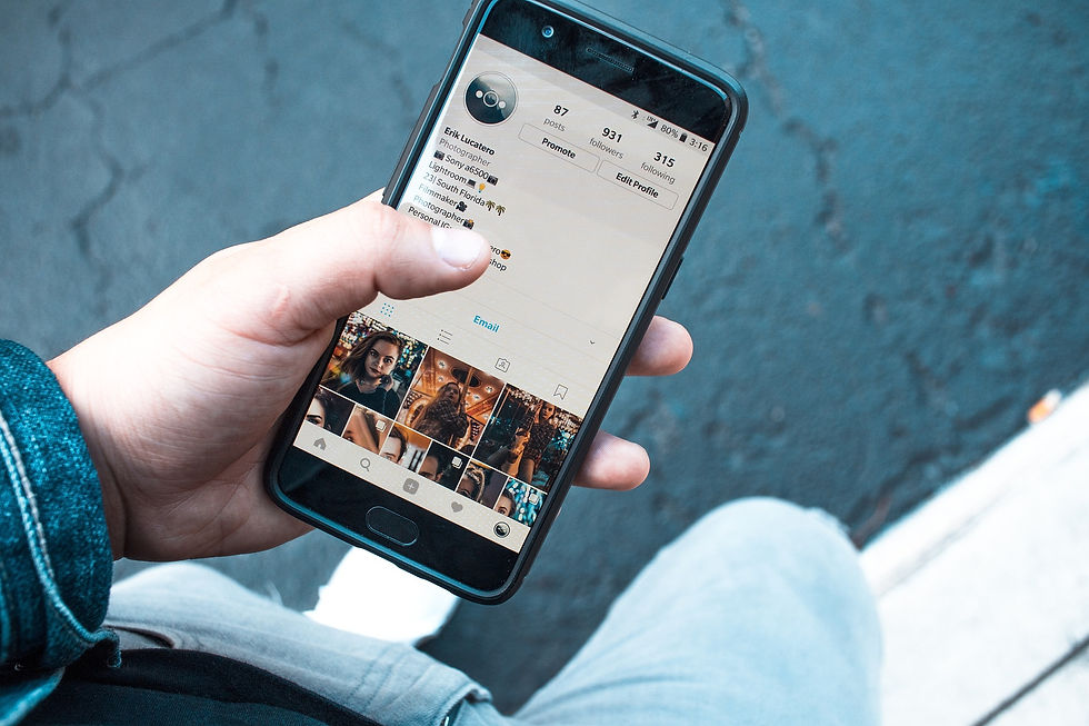 person on their phone looking at an instagram profile