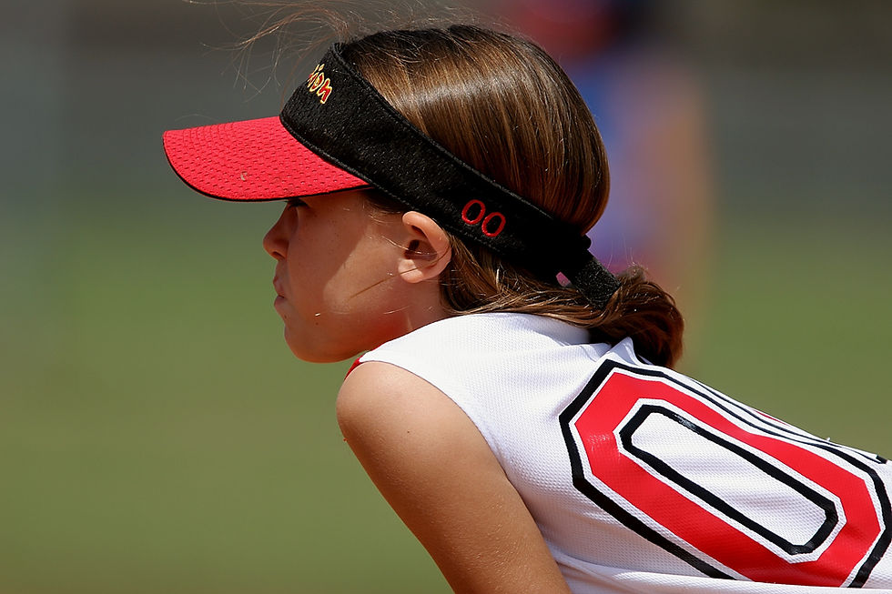 young girl in a softball stance