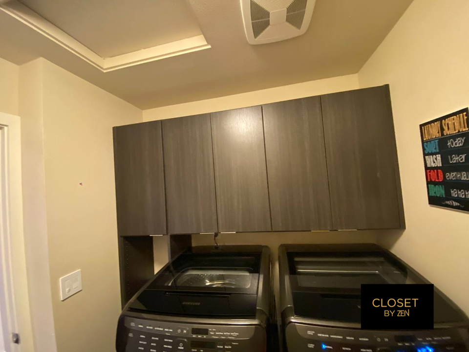 Laundry room with cabinets and two washing machines. CLOSET BY ZEN, Cabinets