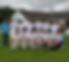 Cricket team in uniform by club building