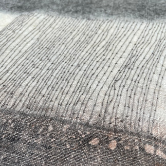 Close-up textile macro photograph revealing intricate woven fabric texture with delicate linear patterns, fine parallel threads, and subtle grey-scale gradations, showcasing detailed textile weave structure and material composition