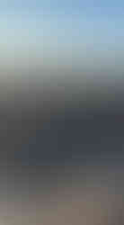 patterns in the sand formed by the sea. Lots of rocks nad a cloudless winter sky