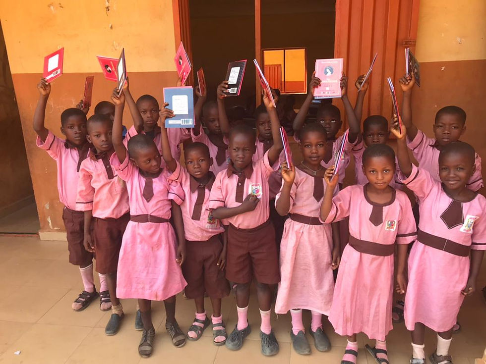 Kids showing FAC donated reading materials
