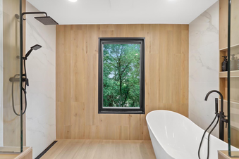 norden smith contracting and remodeling primary bathroom remodel, luxury tile plank walk-in shower, dramatic glass shower walls, tan bathroom tiles, modern bathroom remodel, free standing modern bathtub, rainfall walk in shower, walk-in shower with freestanding tub