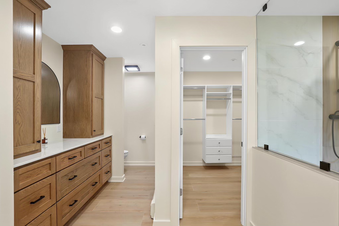 norden smith contracting and remodeling primary bathroom walk in closet remodel with closet system installation white closet organization system