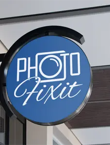 A round, blue sign with a white Photo Fixit logo.