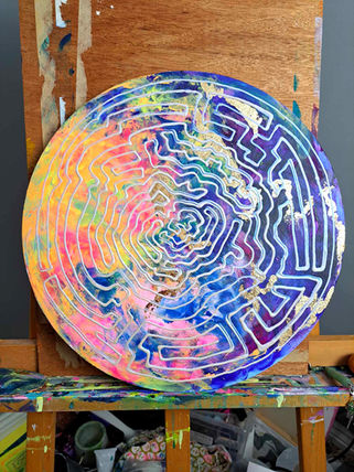 blue, round painting with a seal print over the top