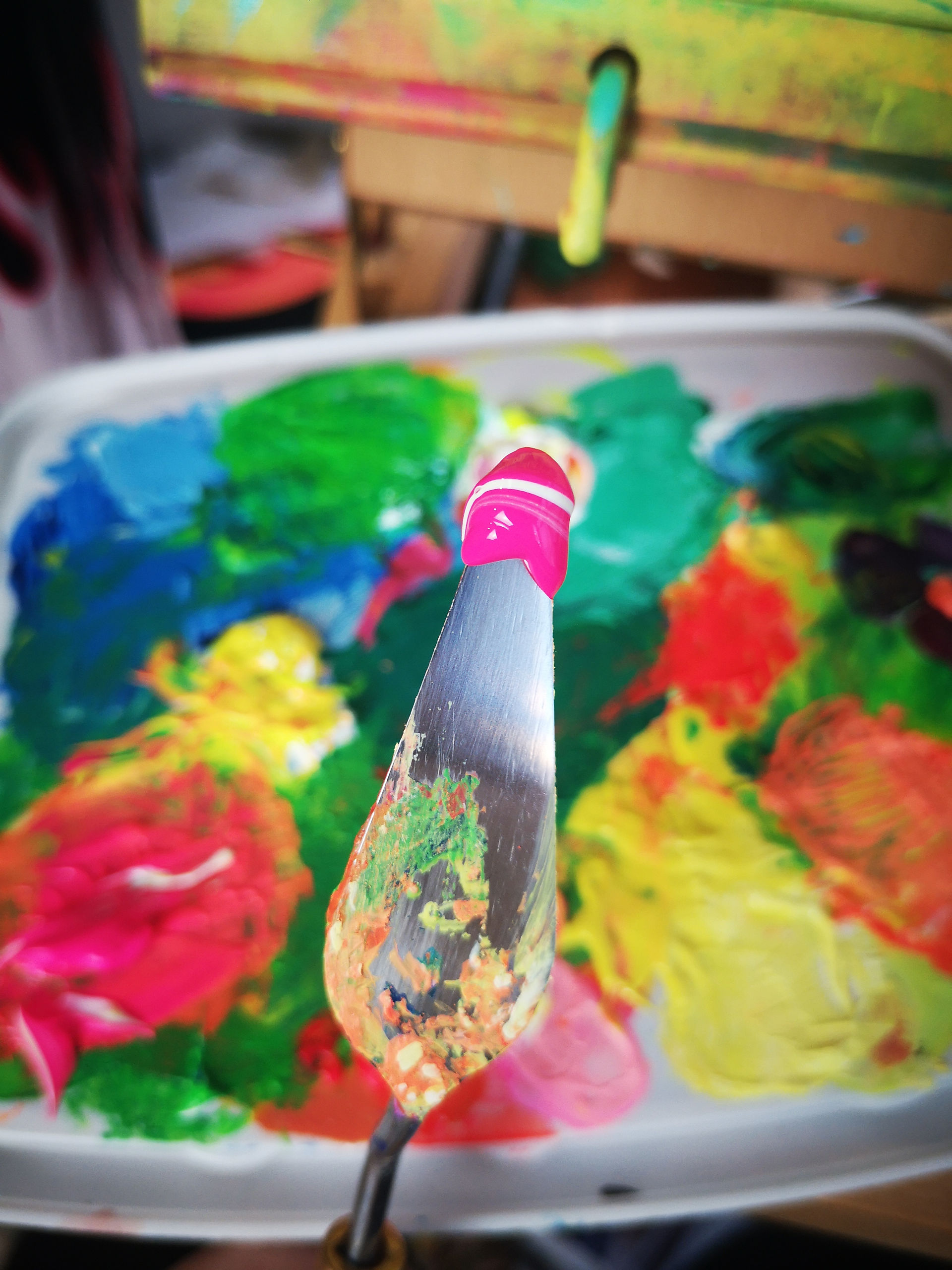 Emily' palette knife covered in neon pink paint