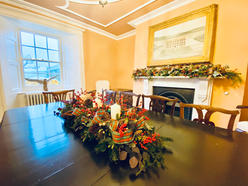 dining table, floral design in the centre, fireplace