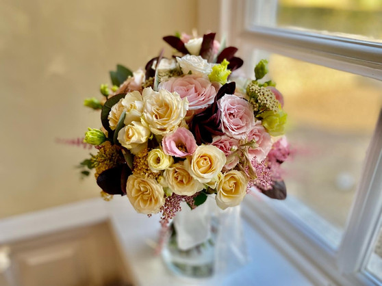 Mixed seasonal peach, pink, orange and plum with contrasting greenery