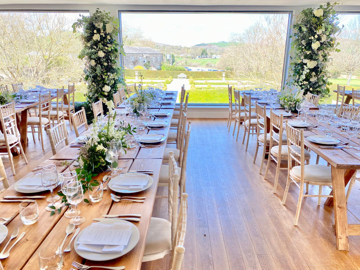 Floral towers, large windows, long tables with cutlery and plates