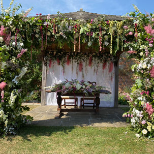 Full floral arch on a wedding ceremony gazebo