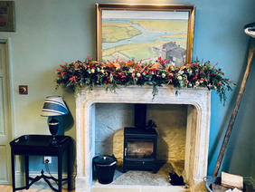 Fireplace with Christmas garland on the mantlepiece