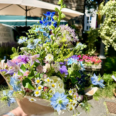 Summer flowers bouquet wit paper wrap outside the florist