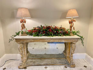 table, two lamps and floral arrangement