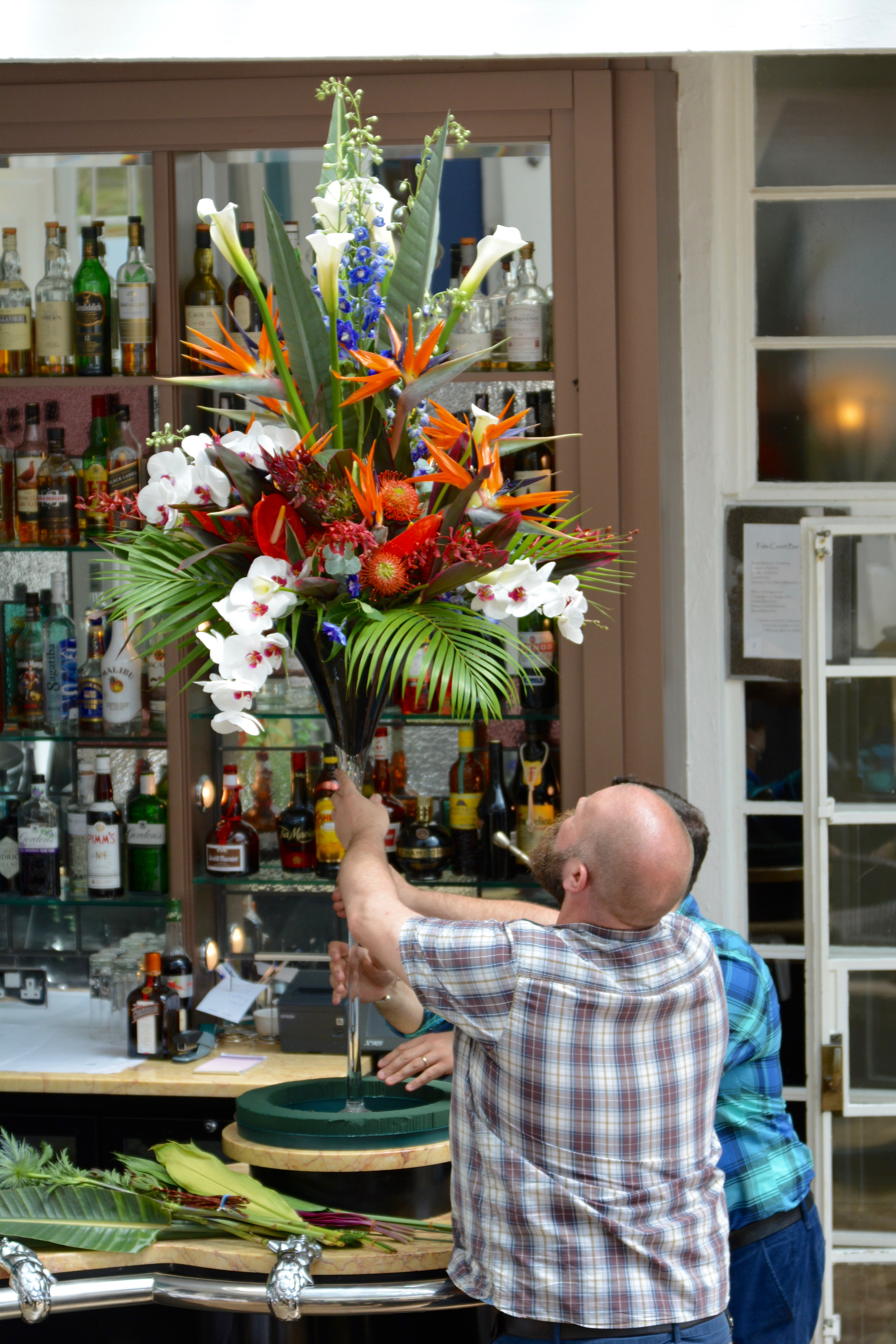 Tropical Flowers in tal vase on bar