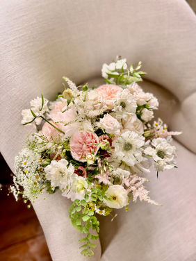 garden style bridal bouquet on a chair 