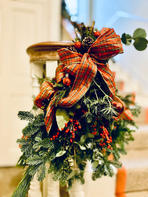 foliage sheaf with tartan ribbon a staircase banister