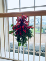 seasonal foliage and tartan ribbon on railings with a window
