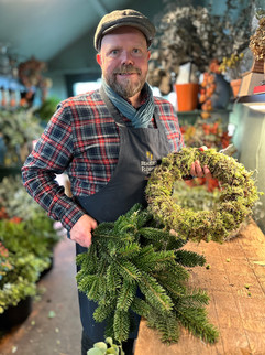 Florist with moss ring and evergreen foliage