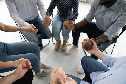 134416143-people-sitting-circle-holding--min.jpg