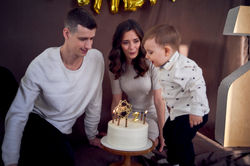 2 year old Harry, blows the candle, as he celebrates his 2 years birthday, with daddy and mummy