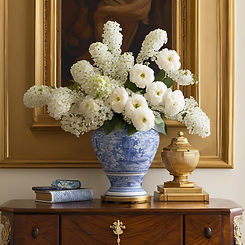 Blue and White vase with white flowers on a rich wood gilded chest similar to a Ralph Laur