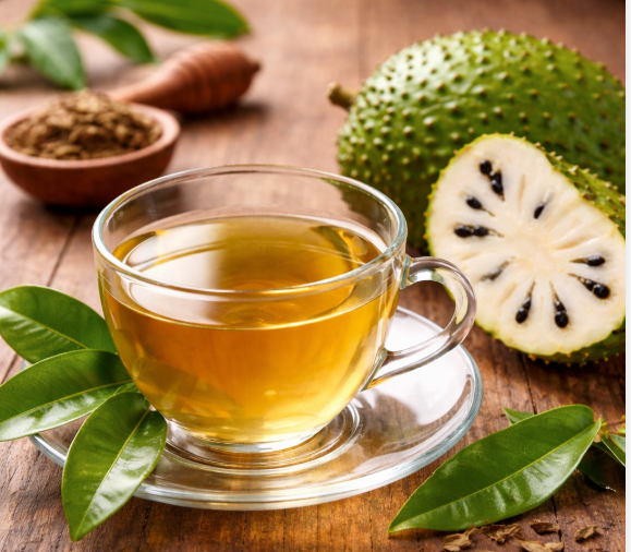 Eye-level view of a cup of herbal tea with Annona muricata leaves beside it