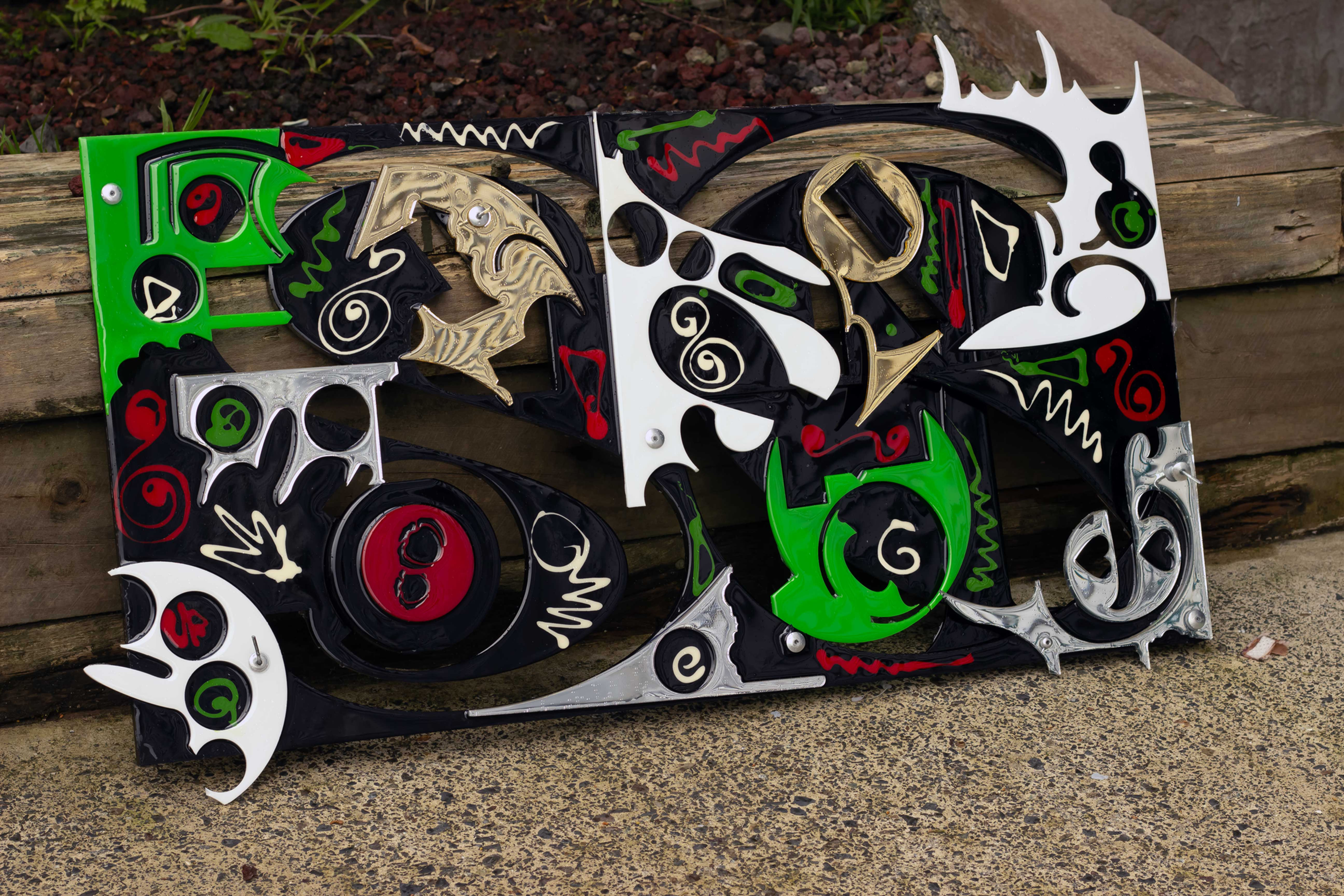 Botanical graffiti wall sculpture in black, green, red and metallic acrylic offcuts with resin by Lisa Watkins