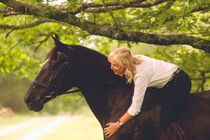 Portrait of a lady on her horse