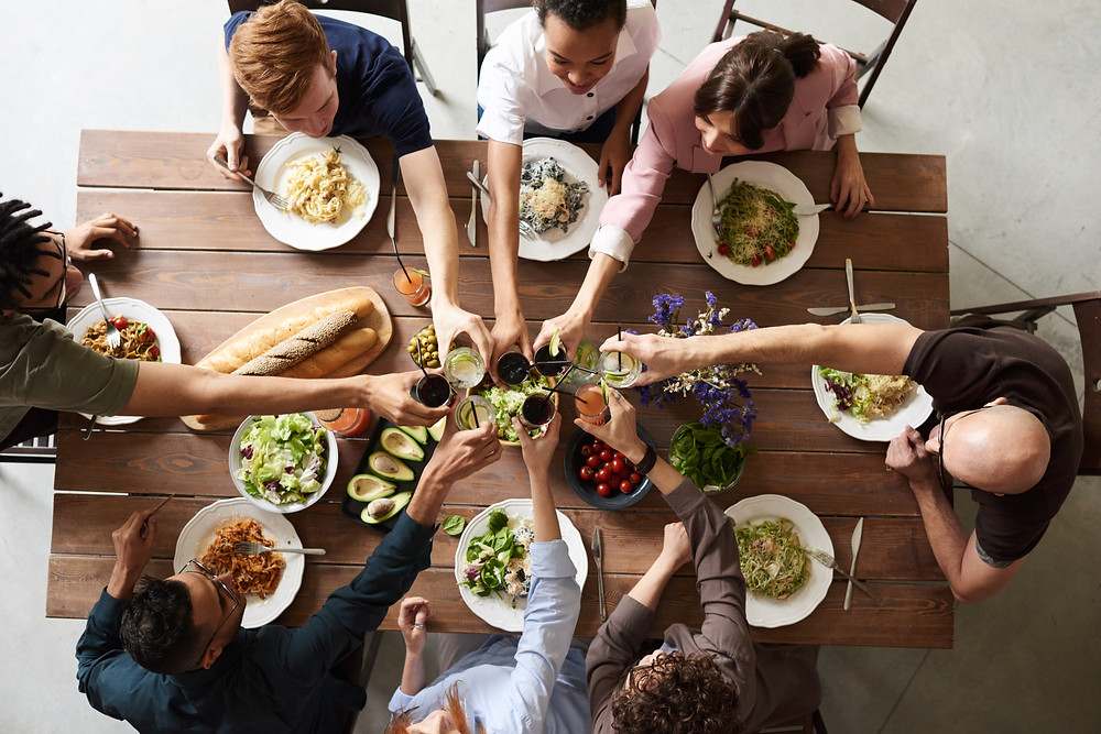 People toasting over meal