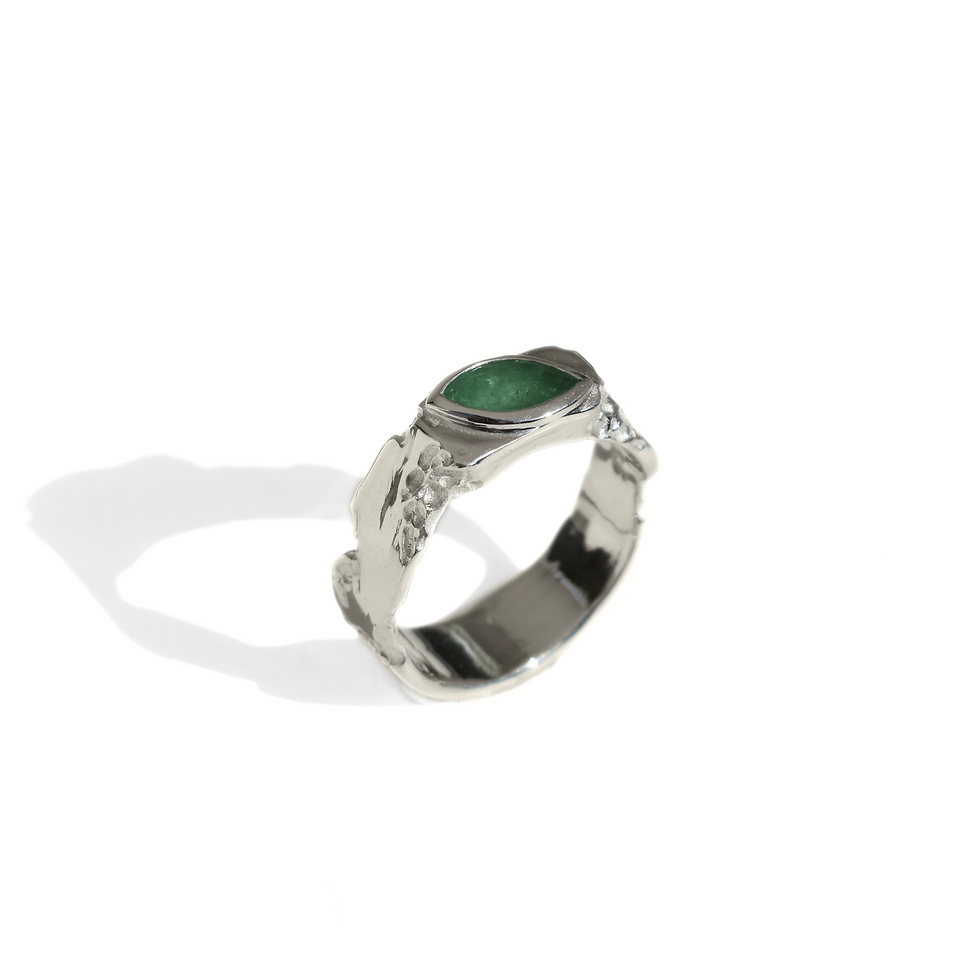 Thumbnail: Silver ring with marquise emerald and rough texture, blending raw nature with refined elegance.