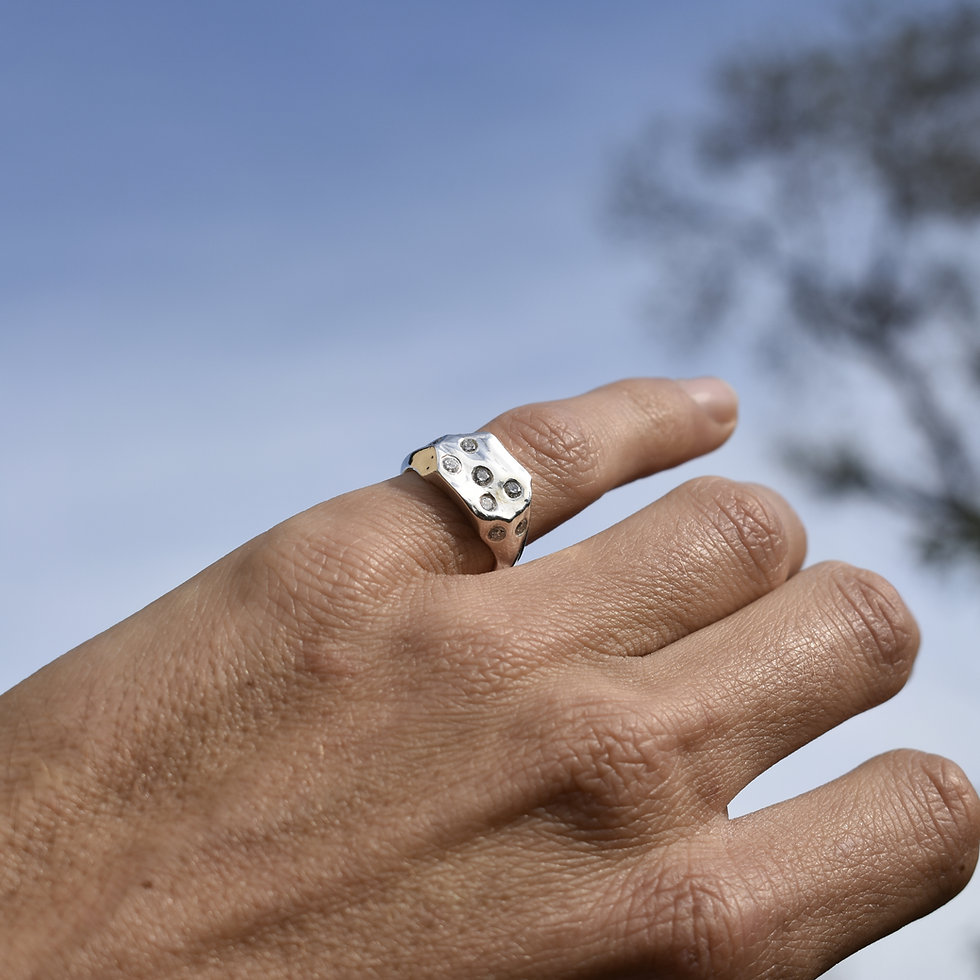Silver organic ring with lab-grown diamonds, sculpted textured design, photographed outdoors.