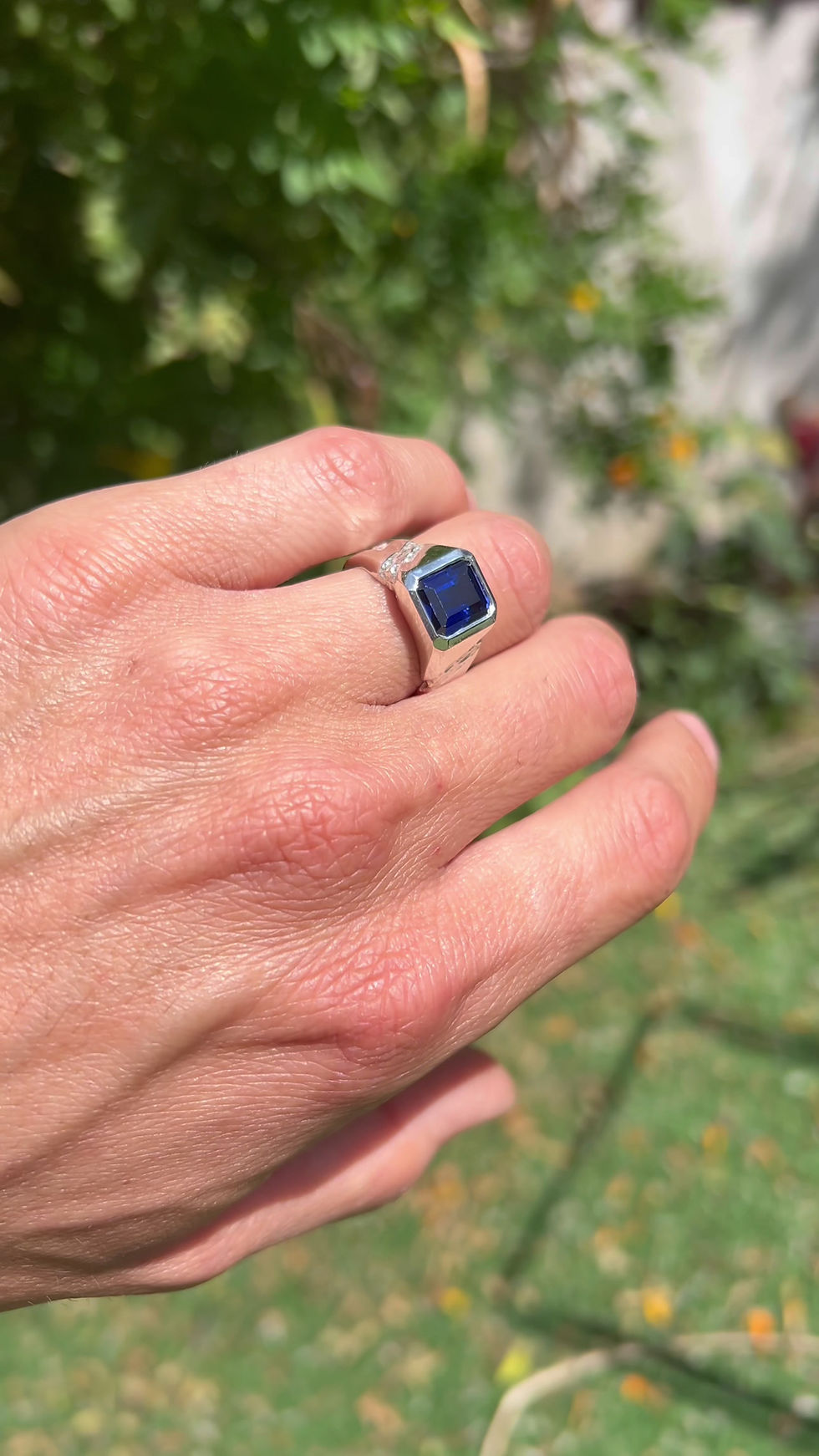 Thumbnail: Handmade silver ring with 10x8 mm lab sapphire, emerald cut, bold modern design with textured band.