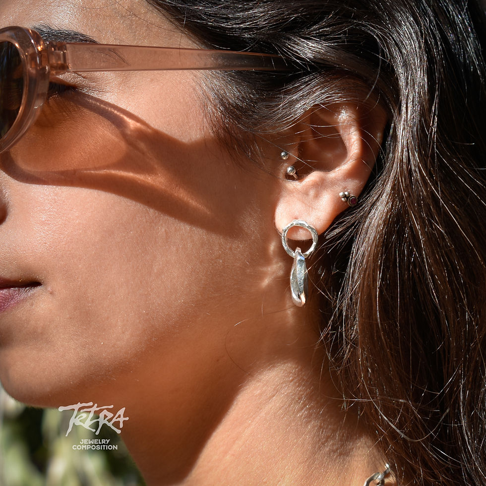 Thumbnail: Handmade sterling silver dangle earrings with hammered texture and organic interlocking hoop design.