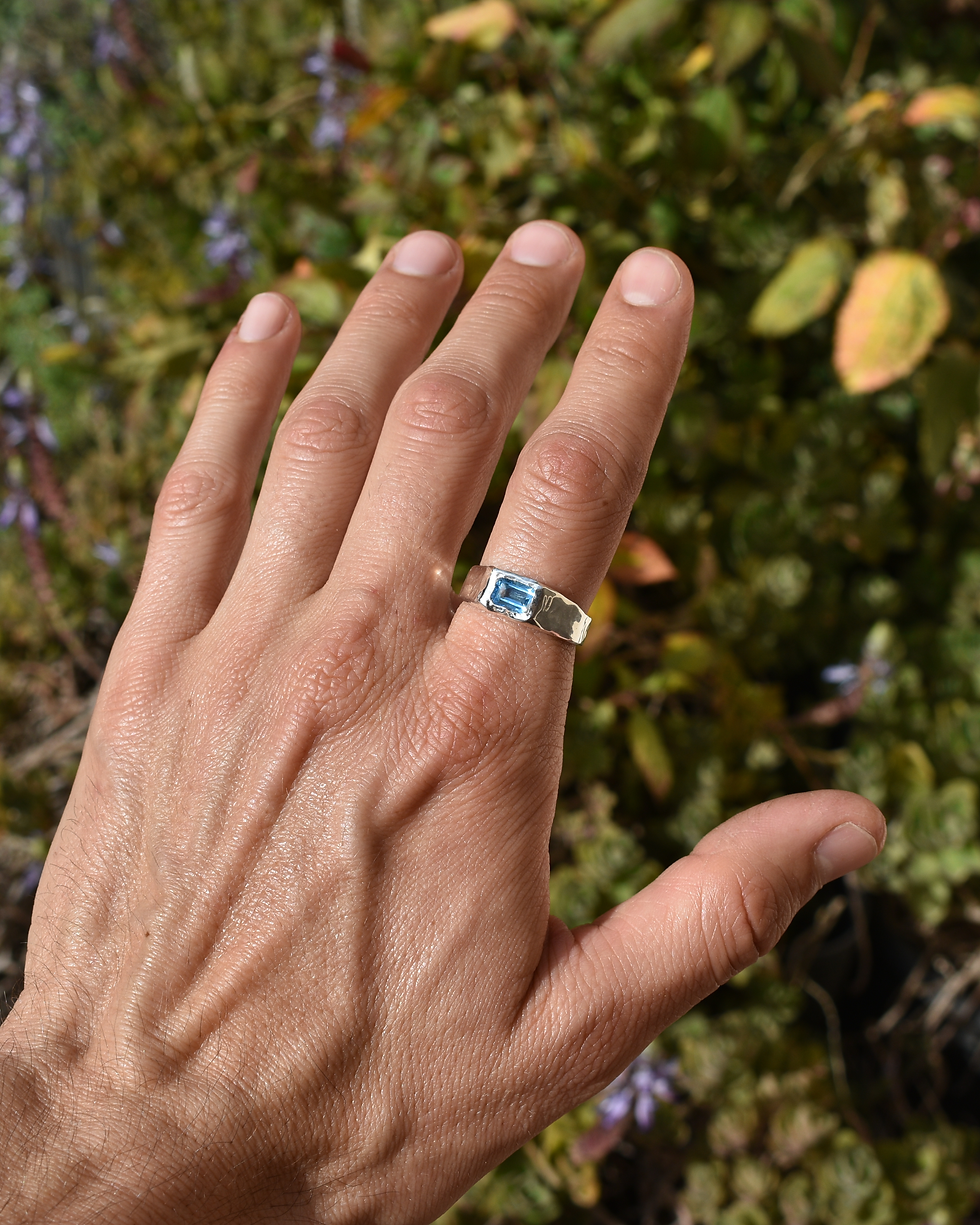 Thumbnail: Handmade sterling silver ring with rectangular blue topaz, polished organic gemstone band with sculptural silver design