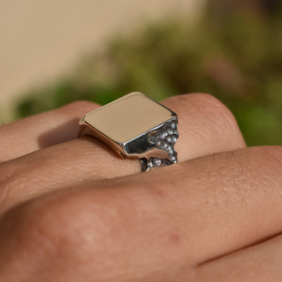 925 sterling silver signet ring with a modern, textured design. A bold and stylish piece.