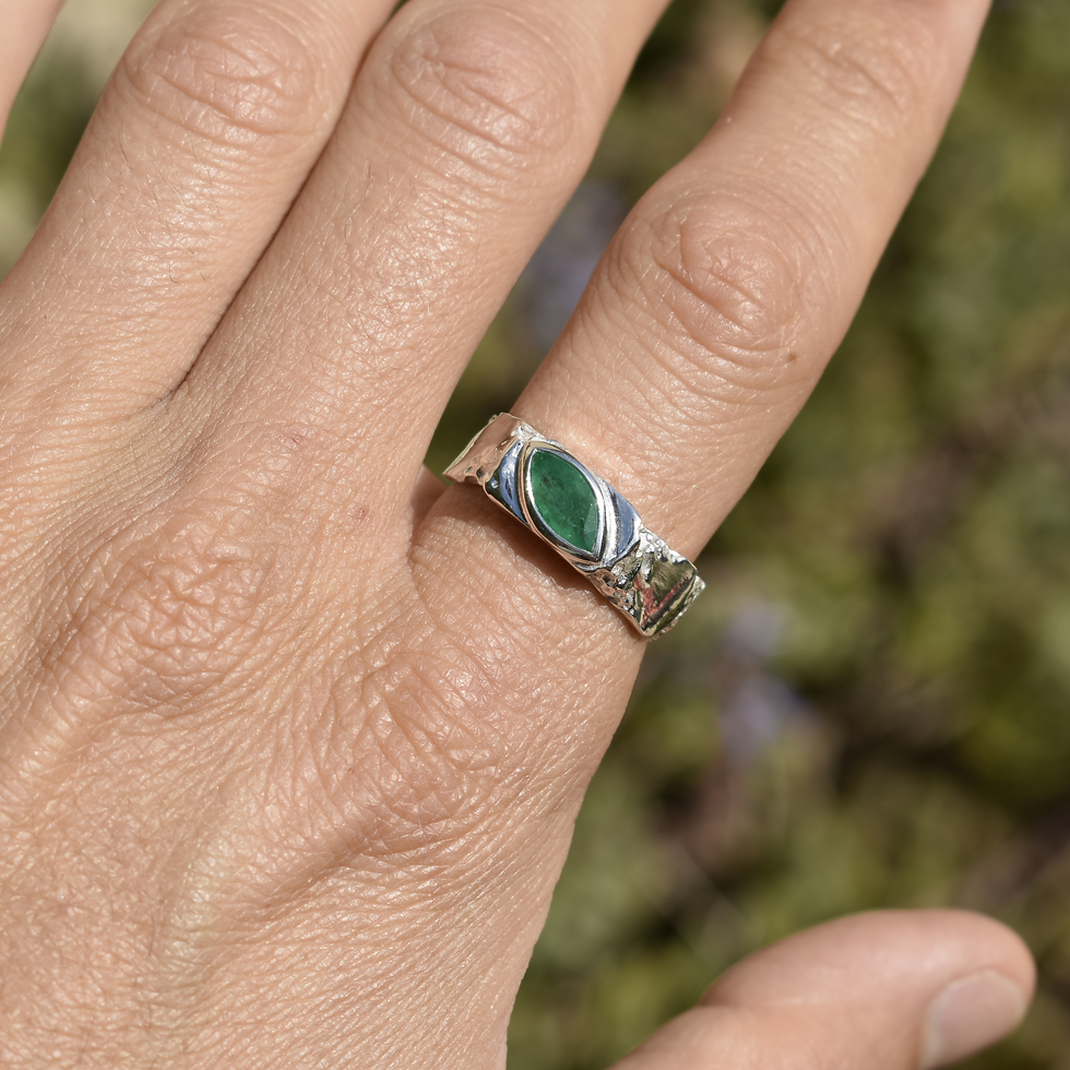 Thumbnail: Silver ring with marquise emerald and rough texture, blending raw nature with refined elegance.