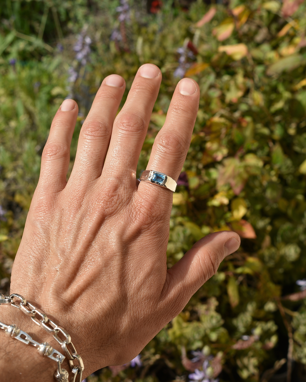 Thumbnail: Handmade sterling silver ring with rectangular blue topaz, polished organic gemstone band with sculptural silver design