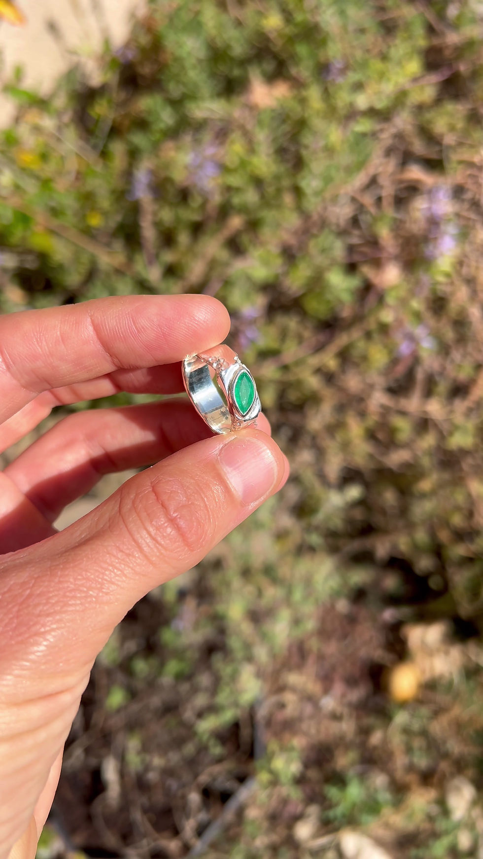 Thumbnail: Silver ring with marquise emerald and rough texture, blending raw nature with refined elegance.