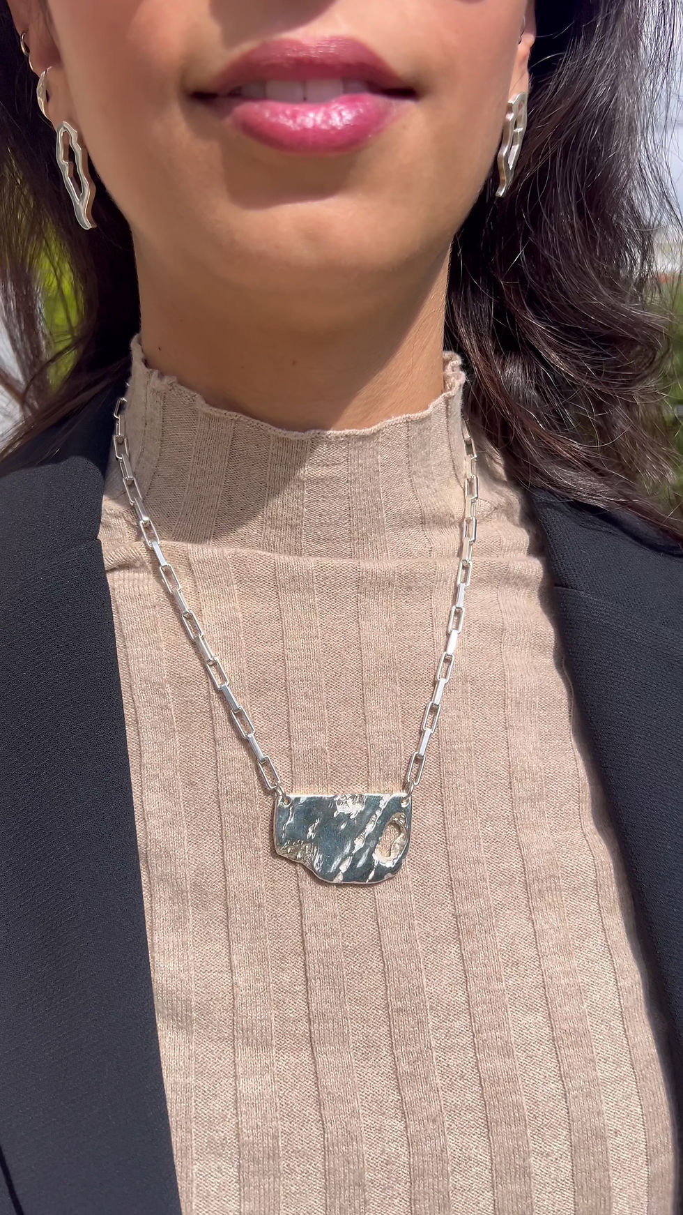Thumbnail: Bold silver pendant with raw stone texture, paired with a sleek rectangular link chain.