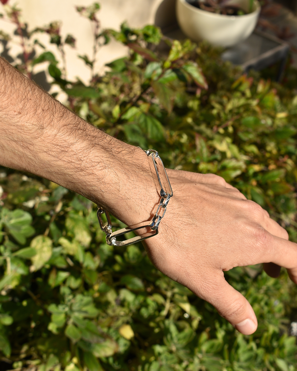 Thumbnail: Handmade sterling silver bracelet with elongated chain links, polished finish, worn on wrist in natural light.