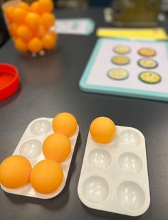 Image shows mini 6 cell muffin tray with ping pong balls