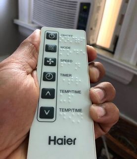 Air conditioner remote control with standard print and braille label