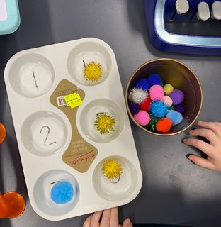 Image shows 6 cell muffin tray with felt balls 