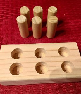 Image shows timber braille cell with removable pegs